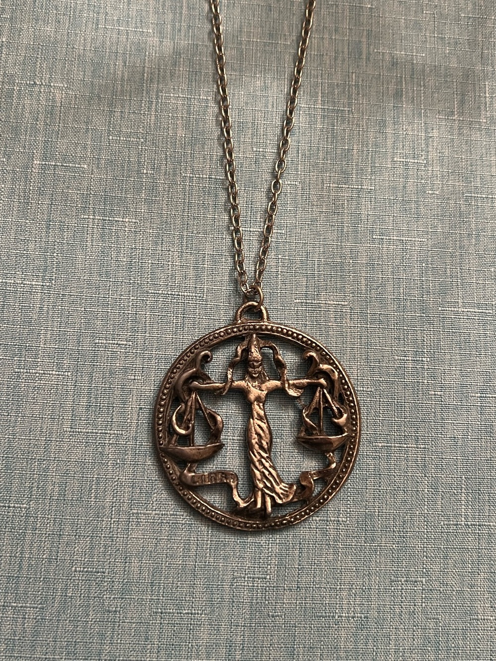 Large Libra zodiac silver tone medallion necklace on 24” chain.